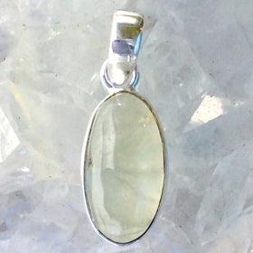 Green Garnet Sterling Oval Pendant is a translucent, light green gem in a traditional setting. The delicate pendant is 1.25" long and set in sterling silver. New Earth Gifts