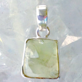 Green Garnet Sterling Free Form Pendant is a dainty 1" long by 1/2" wide. The translucent light green gem shows off beautiful "clouds". Wear casual or dressy. New Earth Gifts