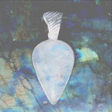 The Rainbow Moonstone Teardrop Sterling Silver Pendant points straight to your heart! The sweet pendant has an interesting "ribbed" bail and lots of rainbows.- New Earth Gifts